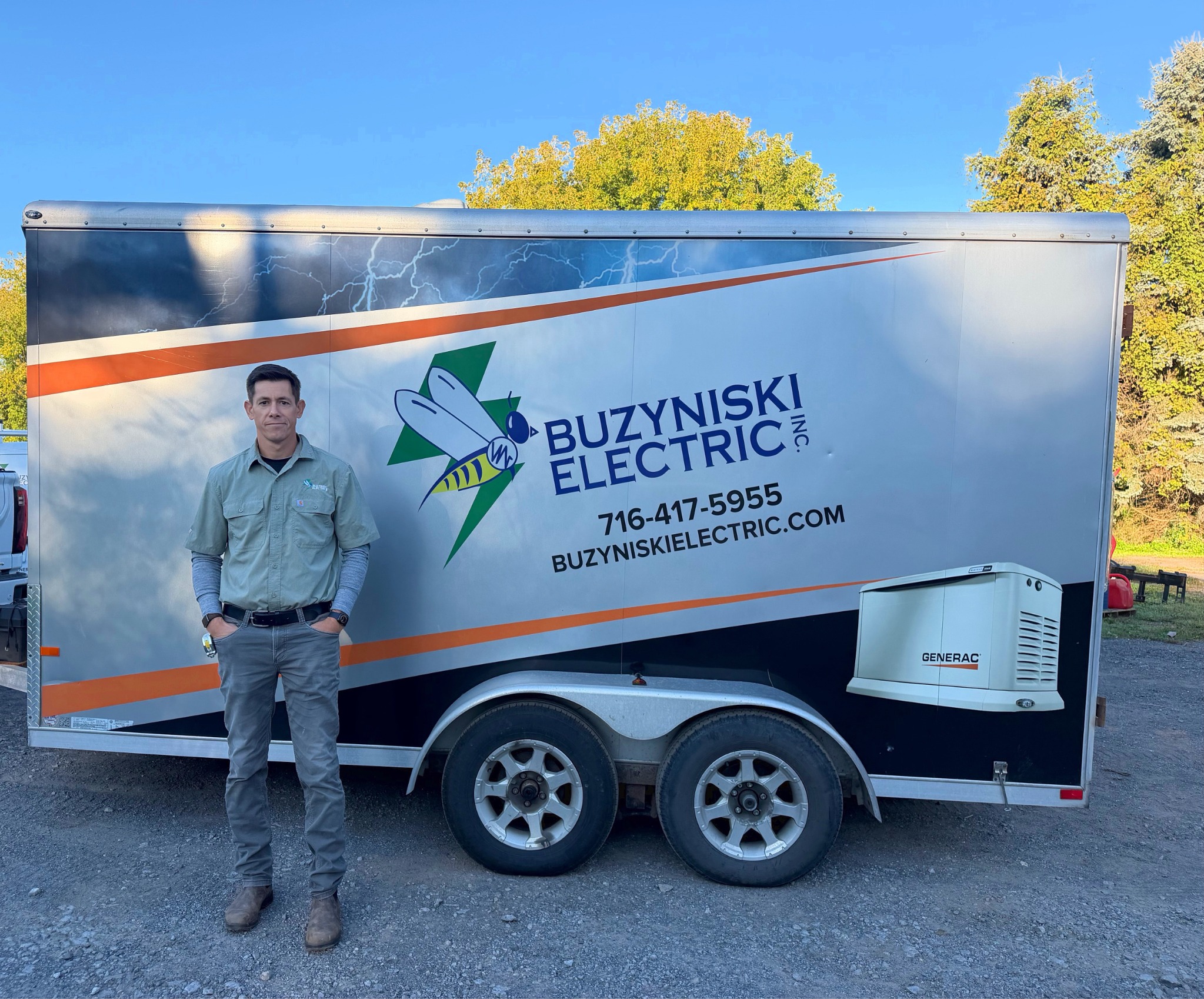 Kyle beside the Buzyniski Electric service trailer
